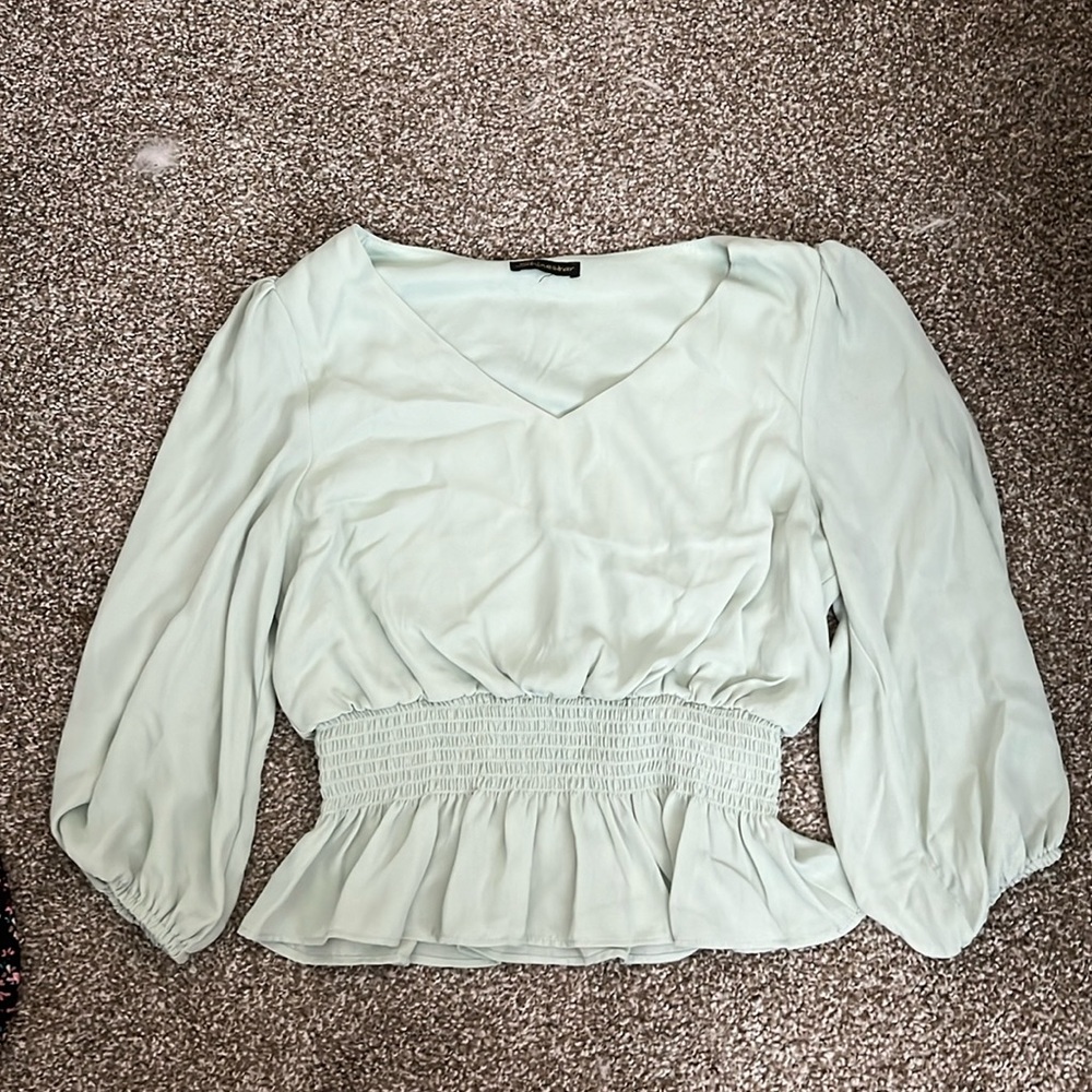 A shinestar mint green gathered and ruffled shirt, sleeves are high rise